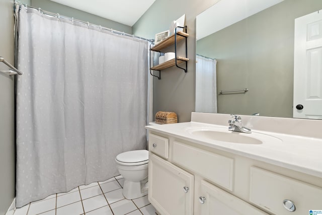 bathroom with tile patterned flooring, vanity, and toilet