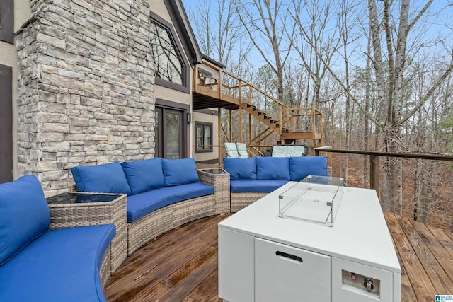 wooden terrace with stairway and an outdoor living space