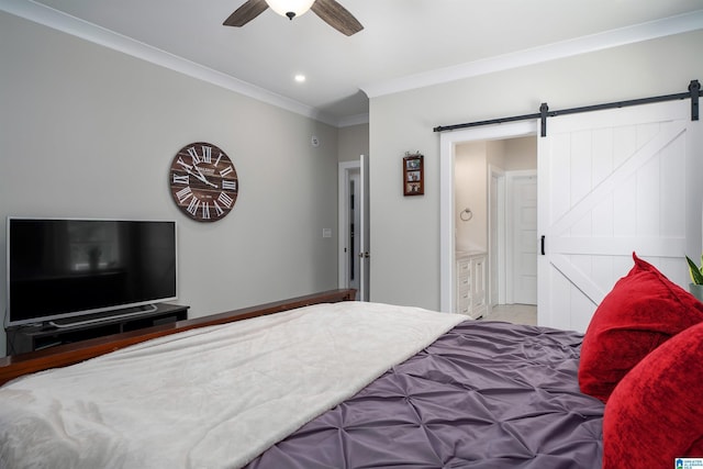 bedroom with ensuite bath, ornamental molding, a barn door, and ceiling fan