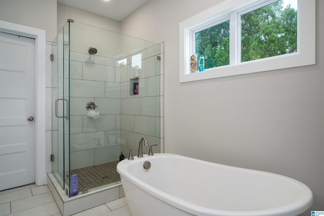 bathroom featuring separate shower and tub