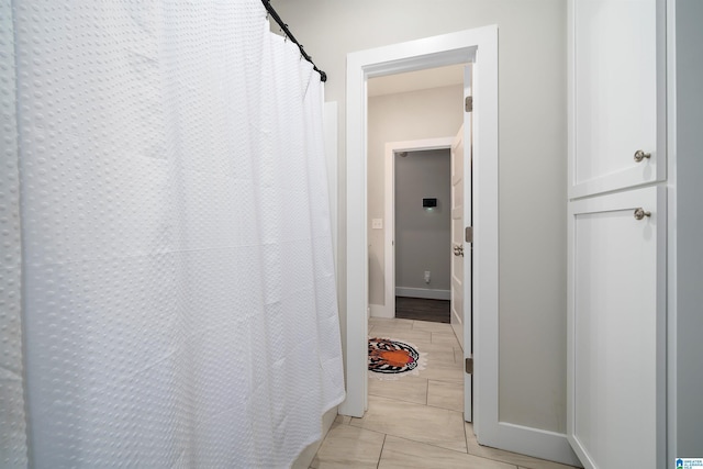 corridor featuring light tile patterned floors