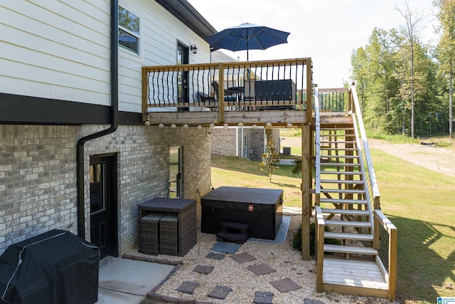 view of patio / terrace with a hot tub, a wooden deck, and a grill