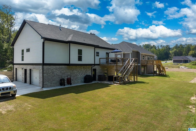 rear view of property with a wooden deck, a garage, a lawn, and cooling unit