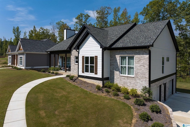 view of front of home with a garage, a front lawn, and covered porch