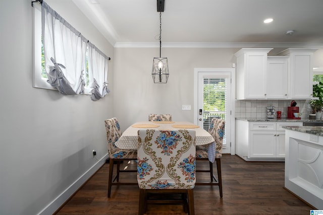 dining area with crown molding and dark wood-type flooring