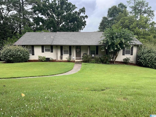 ranch-style home featuring central AC, a front lawn, and a porch