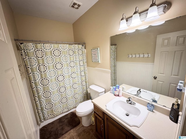 bathroom featuring toilet, vanity, and tile patterned flooring