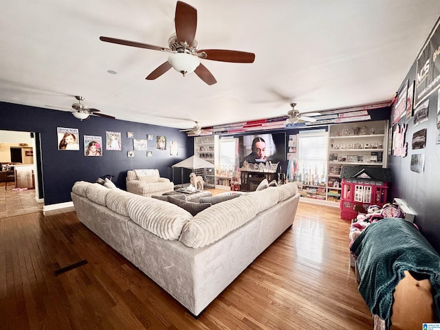 living room featuring hardwood / wood-style flooring and built in shelves