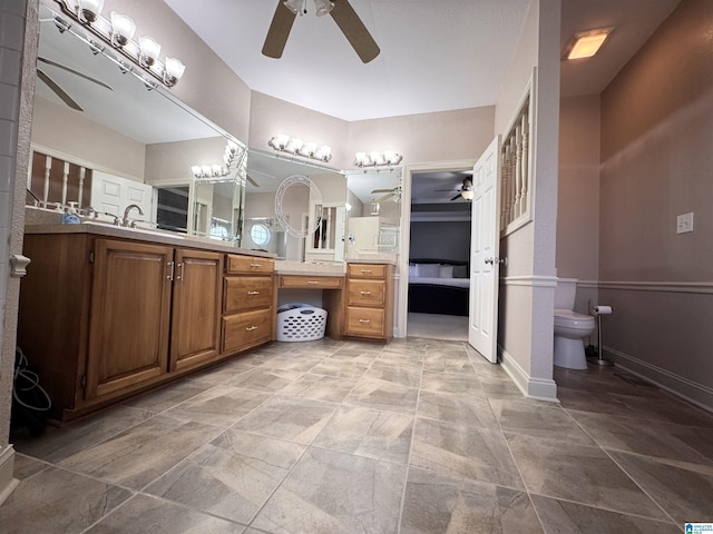 bathroom with toilet, vanity, and ceiling fan