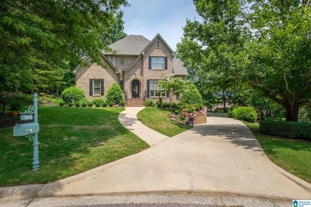 1016 Locksley Cir, Birmingham, AL 35242 - view of front of home with a front yard, brick siding, and driveway