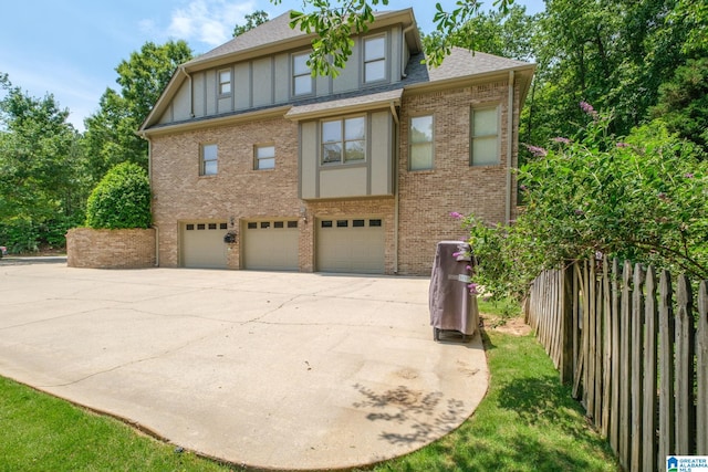 1016 Locksley Cir, Birmingham, AL 35242 - view of front of property featuring a garage, brick siding, driveway, board and batten siding, and a shingled roof