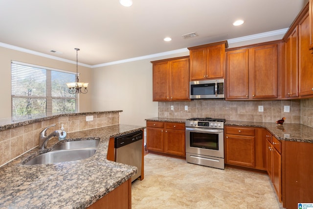 kitchen with pendant lighting, tasteful backsplash, sink, stainless steel appliances, and crown molding