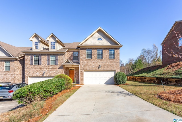 view of front of property featuring a garage and a front lawn