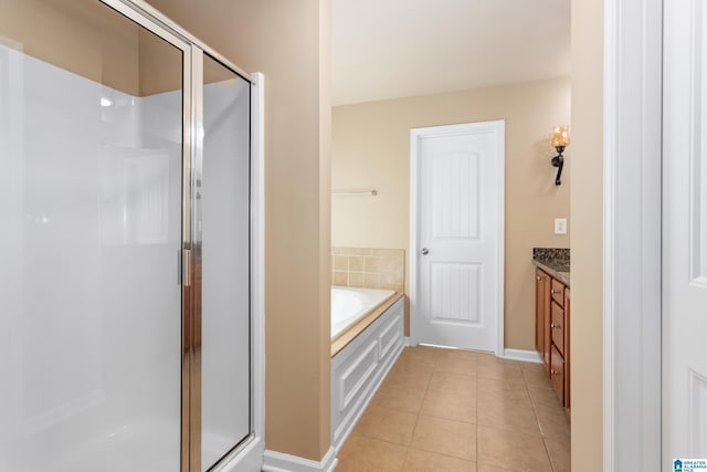 bathroom with tile patterned flooring, vanity, and separate shower and tub