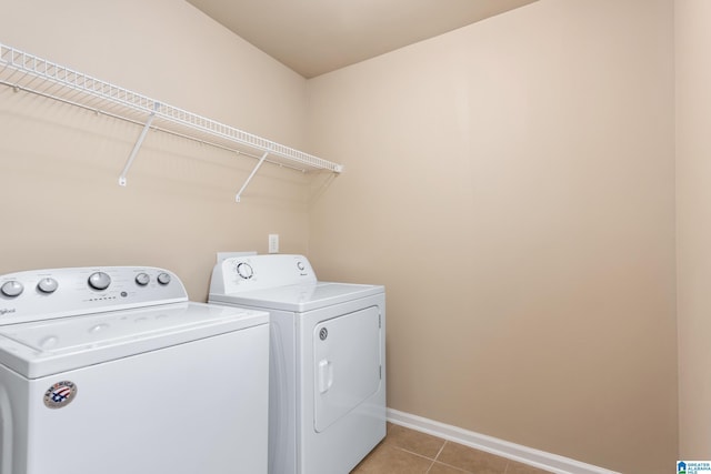 laundry room featuring light tile patterned floors and washer and clothes dryer