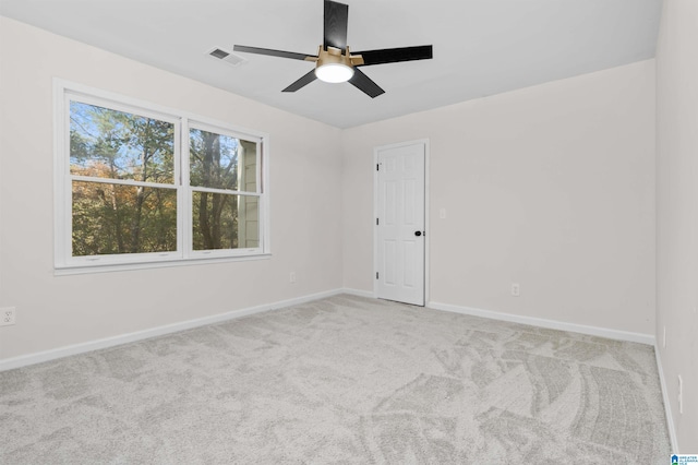 carpeted empty room featuring ceiling fan