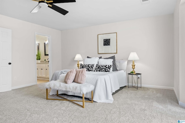 carpeted bedroom with ceiling fan and ensuite bathroom