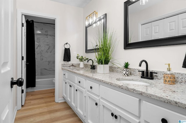 full bathroom featuring tiled shower / bath, wood-type flooring, toilet, and vanity