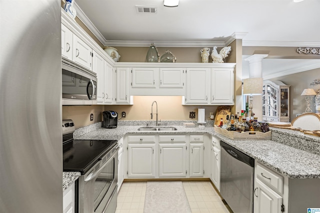 kitchen featuring white cabinetry, sink, stainless steel appliances, and light stone countertops