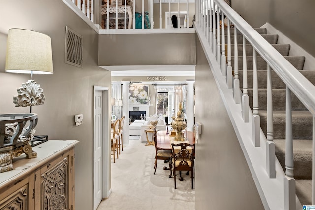 interior space featuring carpet and a high ceiling