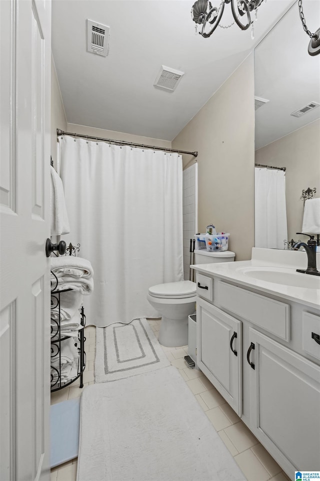 bathroom with vanity, tile patterned floors, and toilet