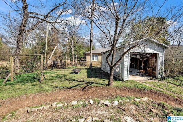 view of yard with a fire pit and fence