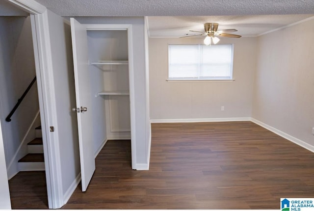 unfurnished bedroom featuring dark wood-type flooring, a closet, and a textured ceiling