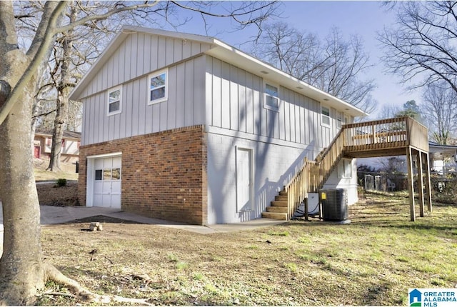 view of home's exterior featuring a garage, a wooden deck, and central air condition unit