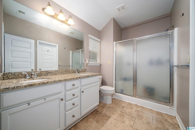 bathroom featuring vanity, toilet, and walk in shower