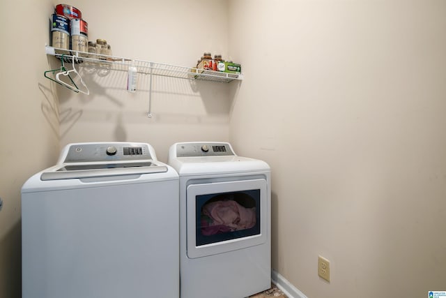 clothes washing area featuring washer and clothes dryer