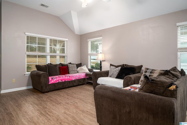 living room with vaulted ceiling and light hardwood / wood-style flooring