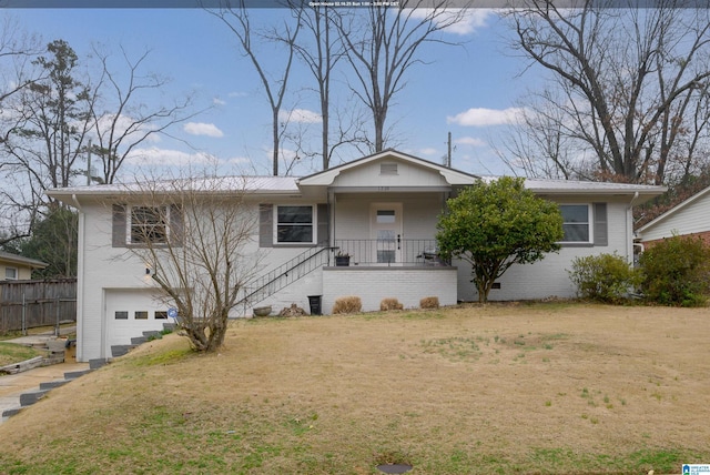 view of front facade with a porch, a garage, and a front yard