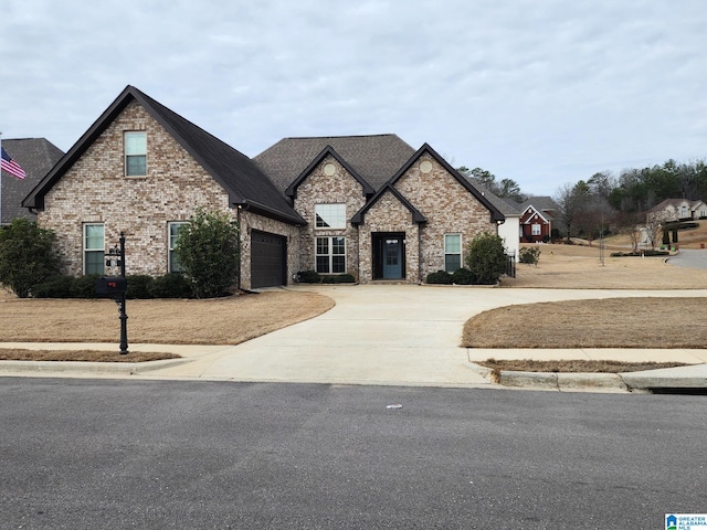 french country style house with a garage