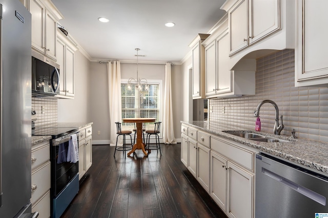 kitchen with sink, pendant lighting, stainless steel appliances, dark hardwood / wood-style flooring, and light stone countertops