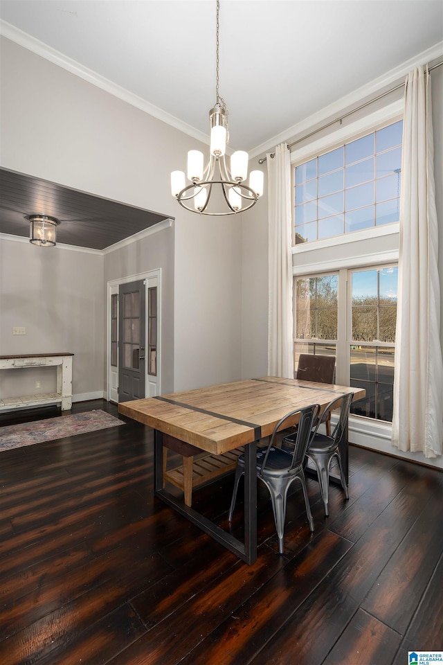 dining space with hardwood / wood-style flooring, a chandelier, and ornamental molding