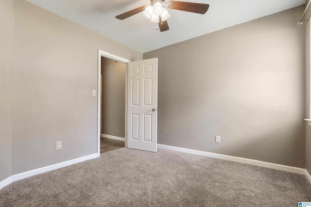 spare room featuring carpet, a textured ceiling, and ceiling fan