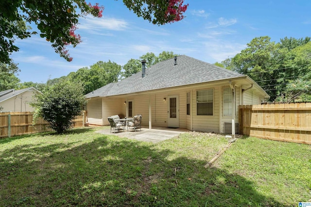 back of house with a yard and a patio area