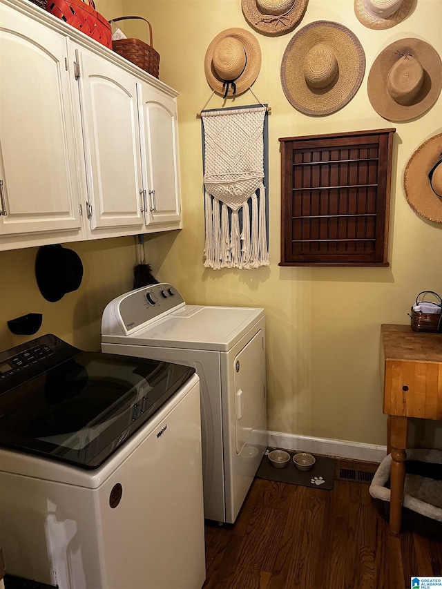 laundry area with cabinet space, visible vents, baseboards, dark wood-style floors, and washer and dryer