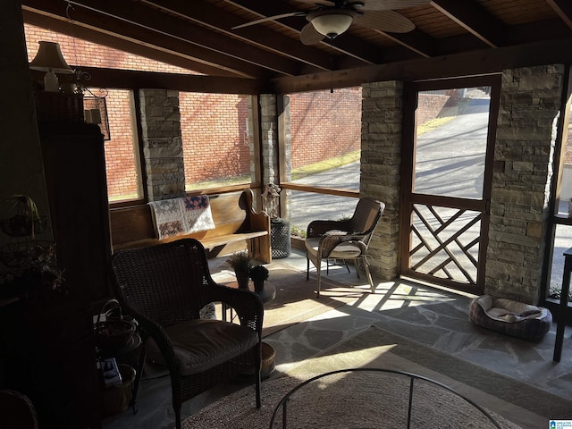 sunroom / solarium with wood ceiling, beamed ceiling, and ceiling fan