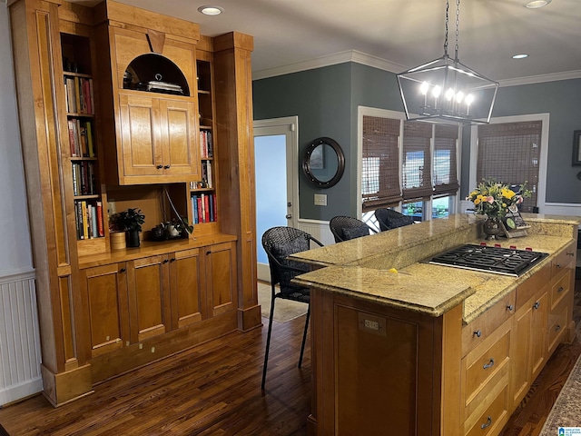 kitchen with a center island, pendant lighting, wainscoting, and stainless steel gas cooktop