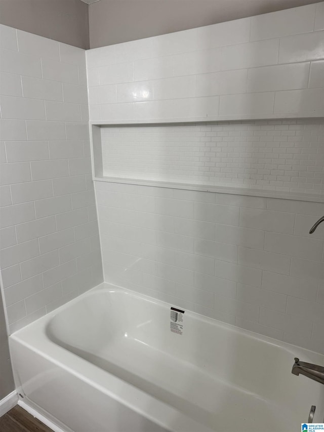 bathroom with bathing tub / shower combination