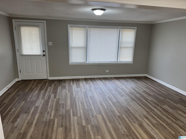 interior space featuring a textured ceiling, baseboards, dark wood finished floors, and crown molding