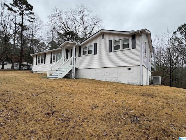 view of front of property featuring central AC and a front lawn