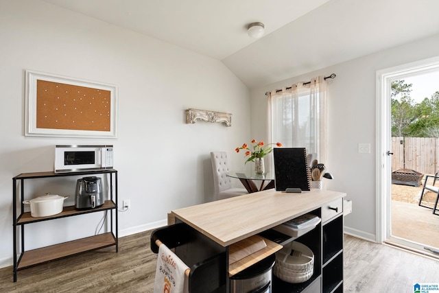 dining space featuring hardwood / wood-style flooring and lofted ceiling