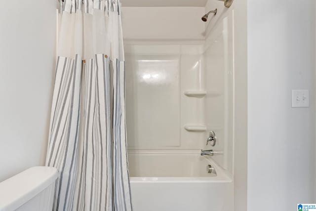 bathroom with toilet and shower / bath combo with shower curtain