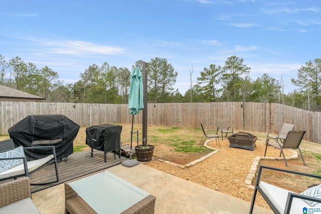 view of patio featuring grilling area and a fire pit