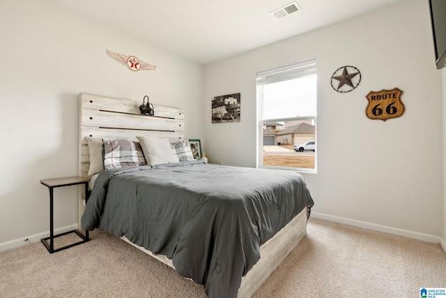 bedroom featuring light colored carpet