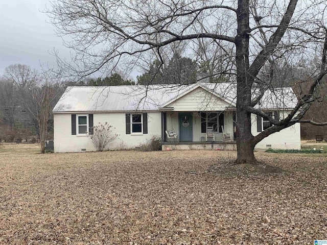 single story home with crawl space, covered porch, metal roof, and brick siding