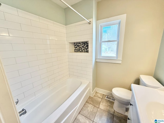 bathroom with toilet, vanity, baseboards, visible vents, and tile patterned floors