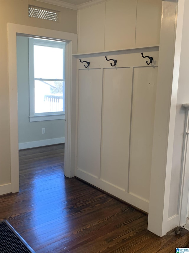 mudroom with dark wood-style floors and baseboards